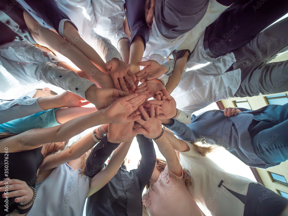 Friendly friends join hands as a sign of joint business. The concept of team and community. Friendly friends join hands as a sign of joint business. The concept of team and community.