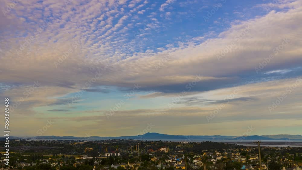 Beautiful skies over Vallejo, Ca. in the early morning at sunrise with clouds moving through the city from above Beautiful skies over Vallejo, Ca. in the early morning at sunrise with clouds moving through the city from above