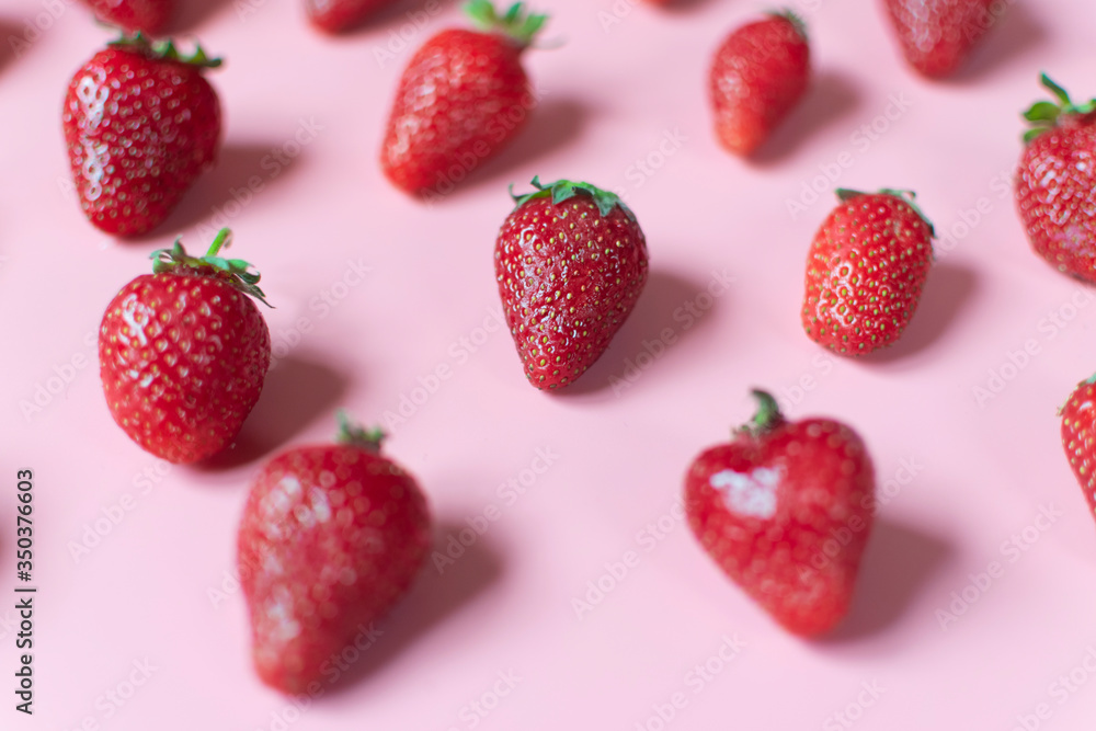 Patern of fresh and juicy red strawberries on pink background Patern of fresh and juicy red strawberries on pink background
