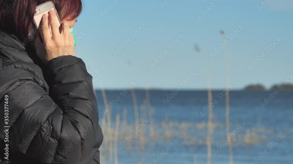 Closer look of the lady talking to her phone in Finland Closer look of the lady talking to her phone in Finland