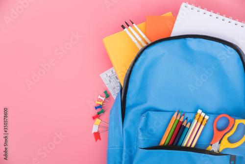 Blue bag backpack for education children on pink background back to school concept © sorapop