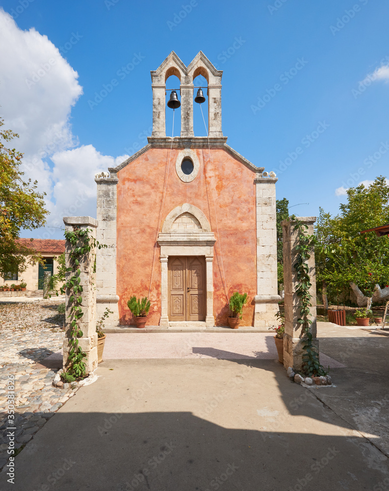 monastry chapel on Crete island with belfry, bell tower. surrounded by monk garden Travel destination, local landmark. Countryside on the Eastern part of the Mediterranean island.