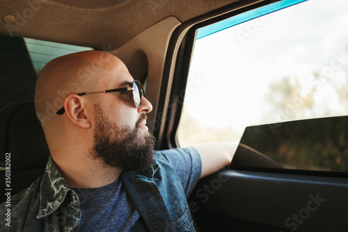 Young man traveling by car. Road car trip lifestyle, destination and travel concept