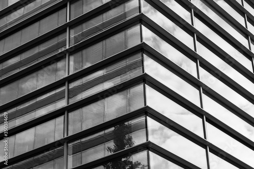 Black and white tone, Close up detail of mixture material exterior facade and wall of glass modern office buildings. Abstract Architectural Geometry with horizontal line of Urban metropolis.