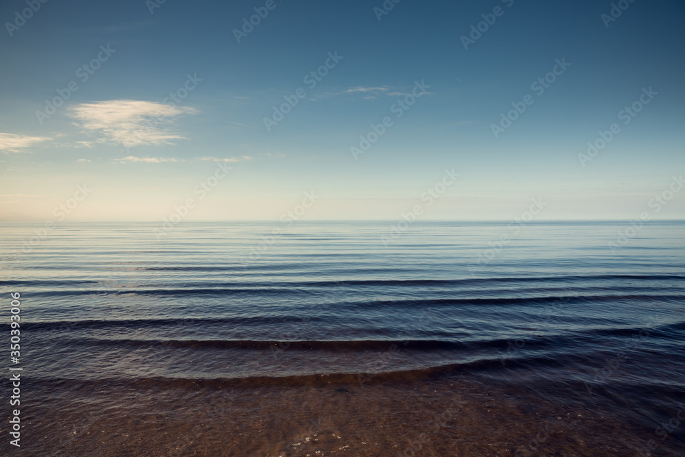 Obraz premium Beautiful light sunset over Baltic sea. Natural background. Latvia. Afterglow, evening calm on the Sea