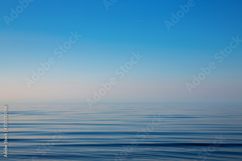 Beautiful light sunset over Baltic sea. Natural background. Latvia. Afterglow, evening calm on the Sea