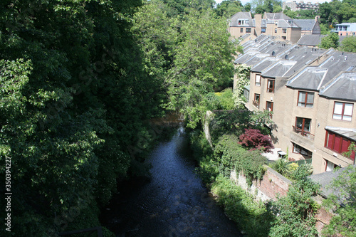 a clean stream next to houses