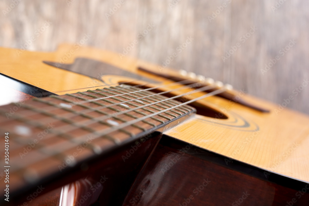 A top down view looking down the neck to the body of an acoustic guitar. A top down view looking down the neck to the body of an acoustic guitar.