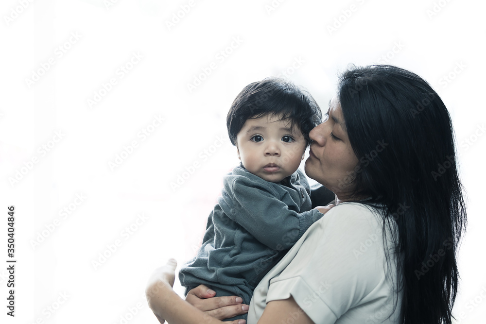 Mexican mother holding her baby boy isolated on white background Mexican mother holding her baby boy isolated on white background