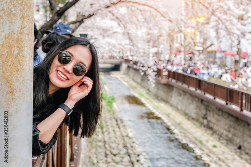 Young woman visiting Jinhae Gunhangje Cherry blossom Festival in South Korea. © sahachat