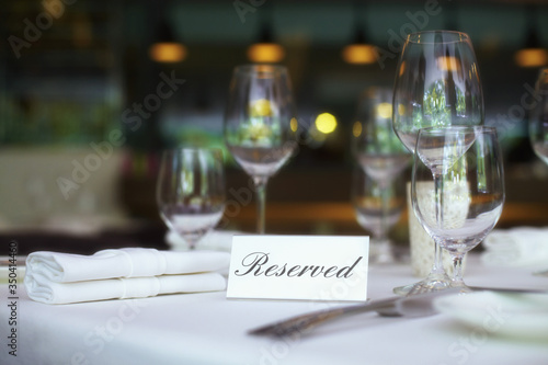 Restaurant table setting with reserved sign