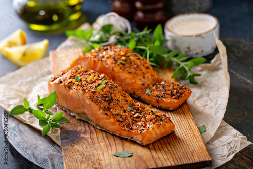 Cedar plank grilled or roasted salmon with herbs, garlic and spices photo