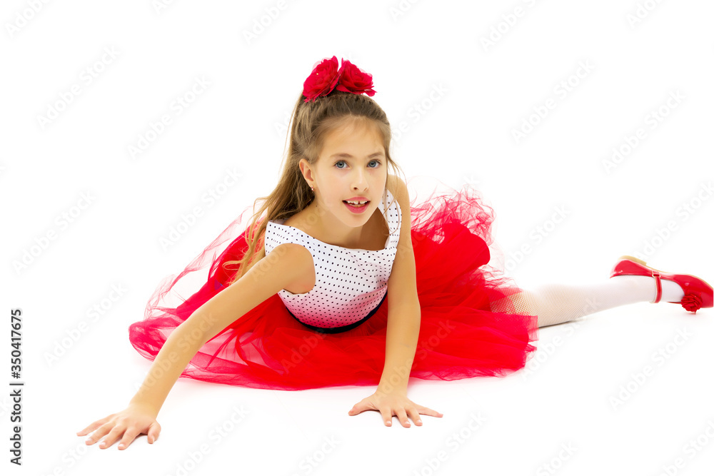 Little girl lies on the floor.Studio photo shoot on a white. Little girl lies on the floor.Studio photo shoot on a white.