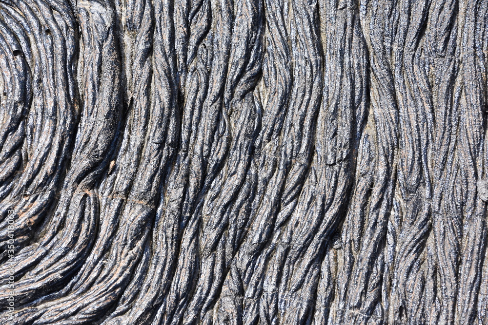 Closeup on Igneous rock dry lava with ripples and cracks Closeup on Igneous rock dry lava with ripples and cracks