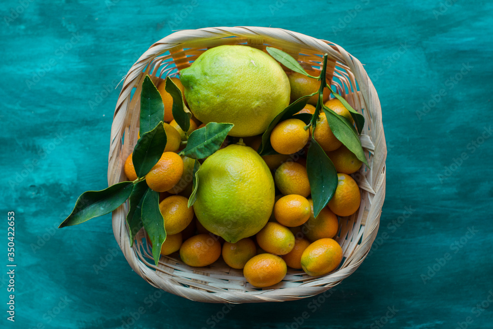 A basked full of kumquats and lemons