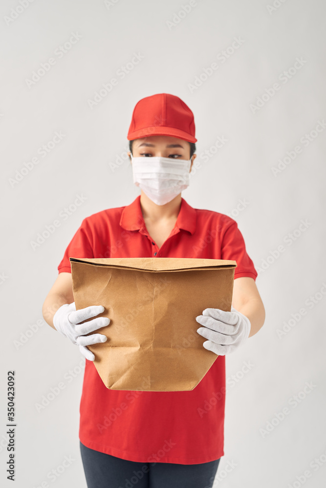 Young asian woman holding delivery paper bag for takeaway food over pink isolated background Young asian woman holding delivery paper bag for takeaway food over pink isolated background