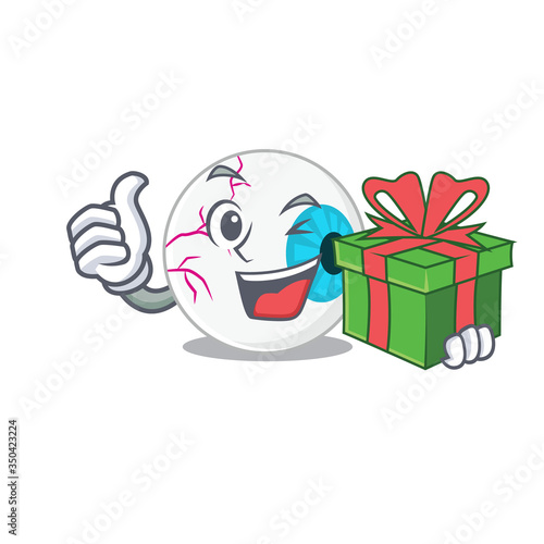 joyful eyeball cartoon character with a big gift box