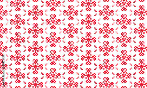 Red hearts made from square blocks make a floral design in a repeating seamless pattern isolated on a white background