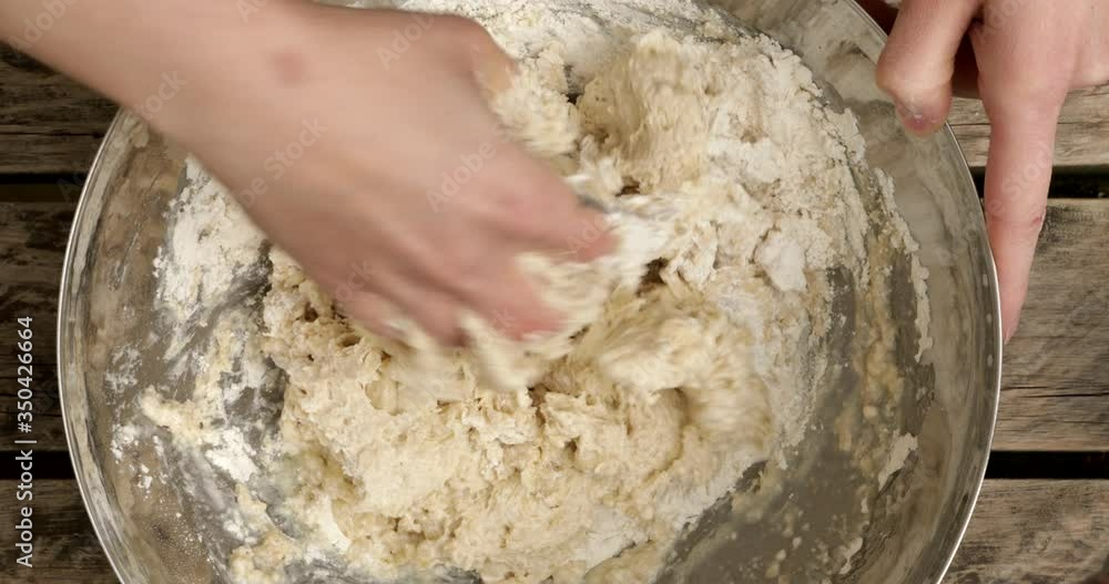 Hand mixing dough in a bowl Hand mixing dough in a bowl