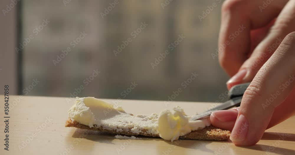 A sandwich with cucumber cheese and fish. A hand that makes a sandwich. Morning, vegetarian food, healthy food, eco, diet. Close-up shot. A sandwich with cucumber cheese and fish. A hand that makes a sandwich. Morning, vegetarian food, healthy food, eco, diet. Close-up shot.