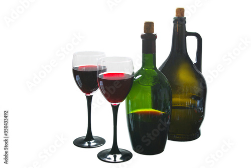 Two bottles of wine and two glasses of wine. Isolated on white.