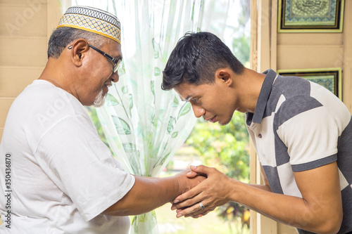 Man greeting his father with handshake