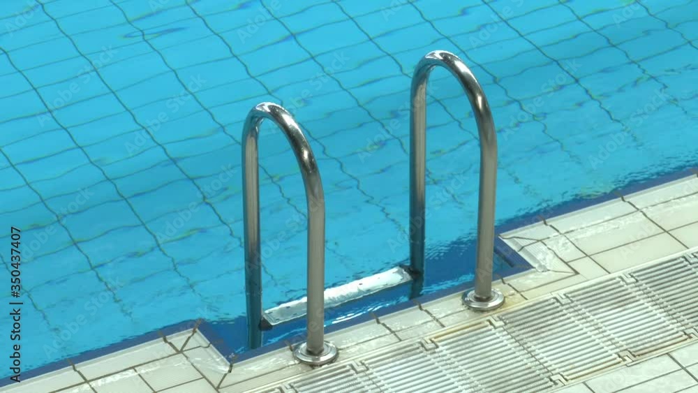 Swimming pool with stair and handrail. stair of swimming pool with blue water
Swimming pool with stair and handrail. stair of swimming pool with blue water