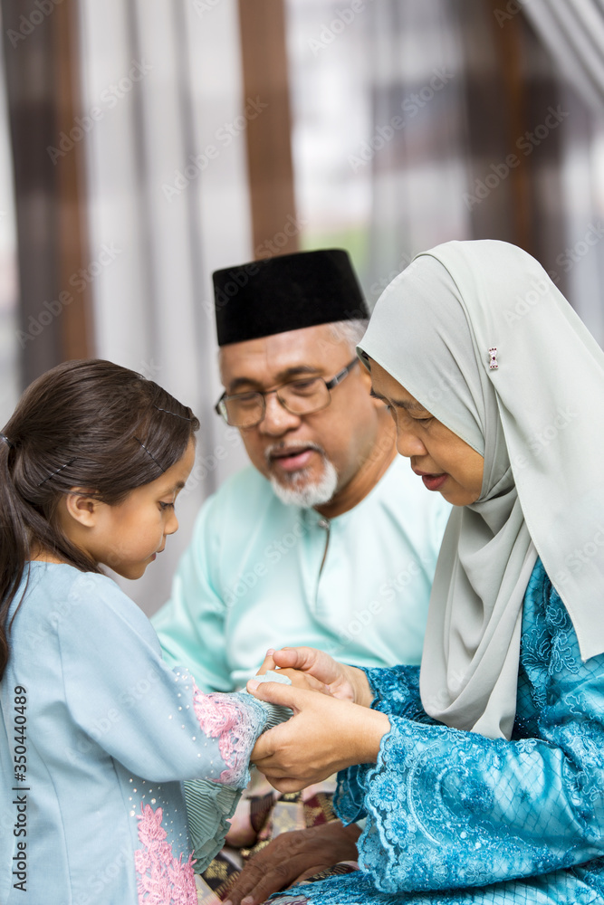 Traditional act of respect in Muslim family on Eid al-Fitr Traditional act of respect in Muslim family on Eid al-Fitr