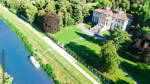 Obraz na plátne Aerial top view of ancient villa Giovanelli, garden and houseboat barge on canal