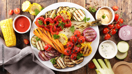 grilled colorful vegetables, aubergine, zucchini, bell pepper, celery, onion, corn with basil