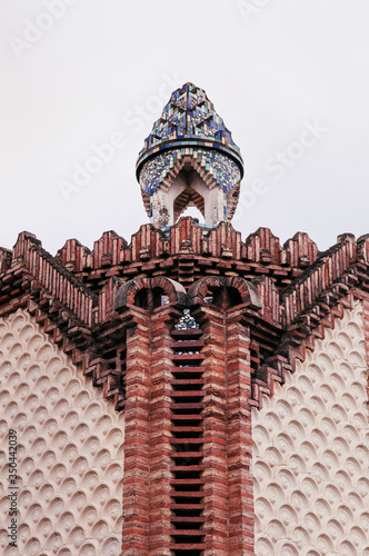 Red brick ornate vintage wall of Pavilion Guell in Barcelona  Spain.