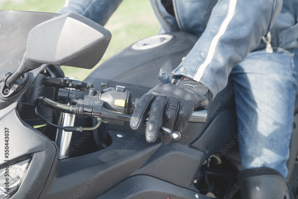 Fototapeta premium Caucasian motorcyclist with a black glove. Transport