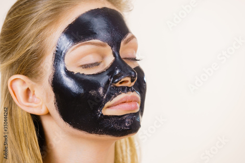 Girl black carbo peel off mask on face