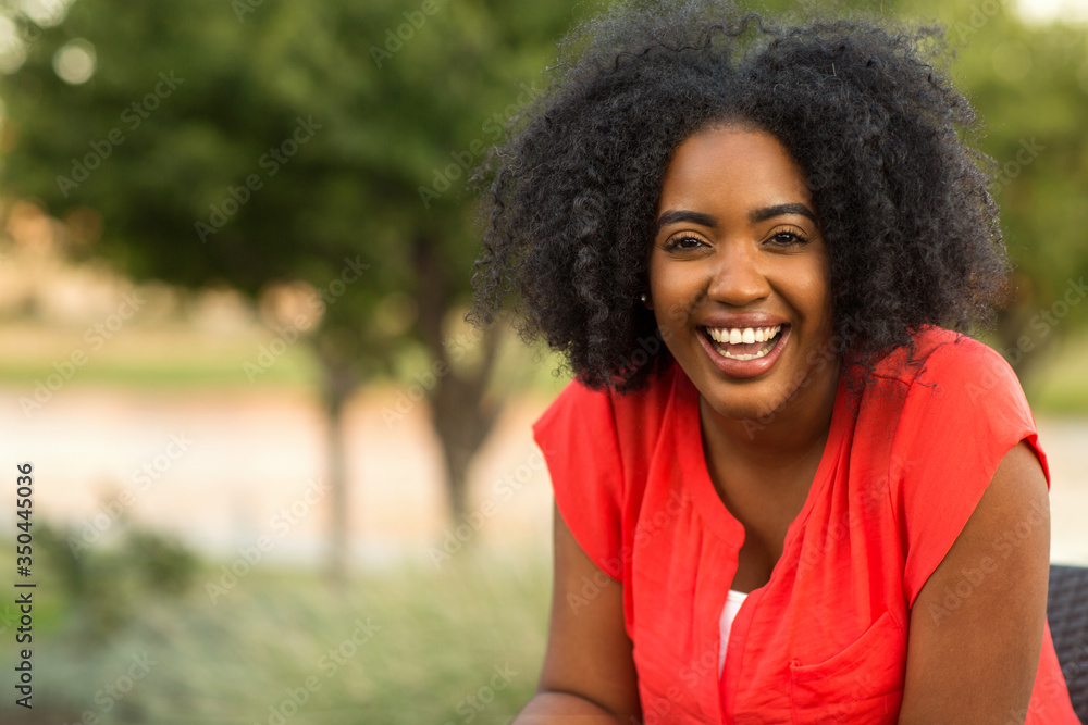 Fototapeta premium Happy confident African American woman smiling outside.