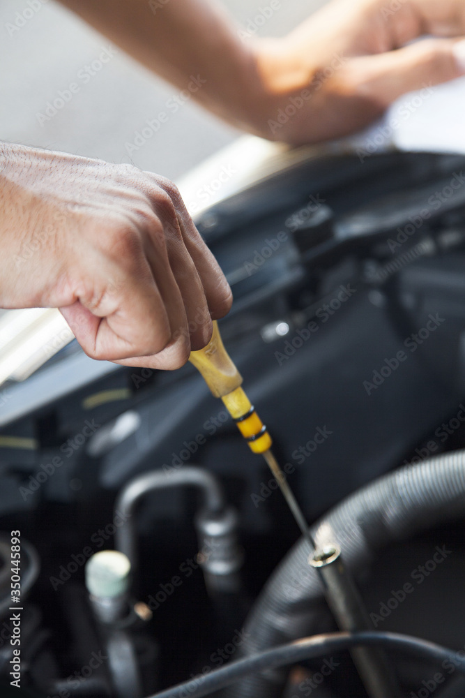 Man checking motor oil level