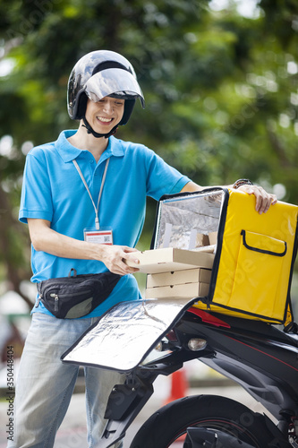 Food delivery man taking food from a bag