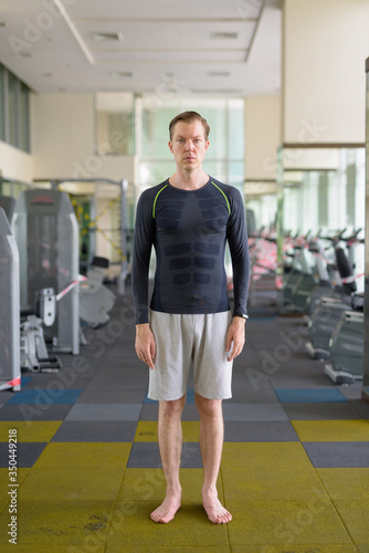 Full body shot of young handsome man at the gym during covid-19 © Ranta Images