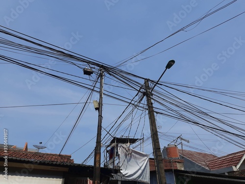 Electric cables on the roof of a house in Jakarta. household cables that are not neatly arranged.