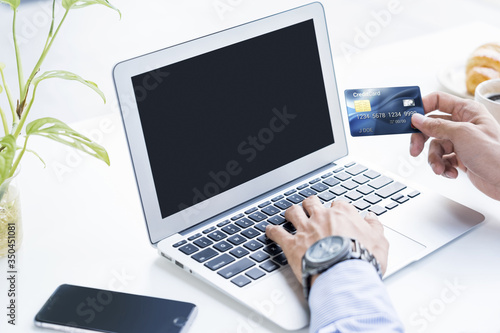 Man holding a credit card for online shopping