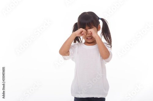 Portrait of little girl crying.on white background.