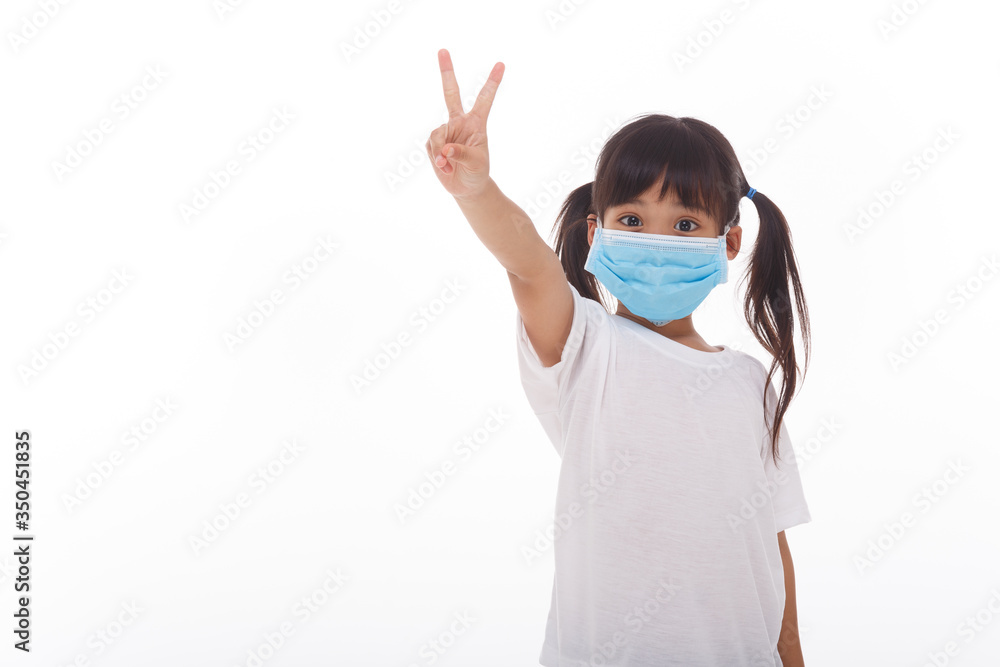 Little asian girl wearing mask holding hands up with two fingers Little asian girl wearing mask holding hands up with two fingers