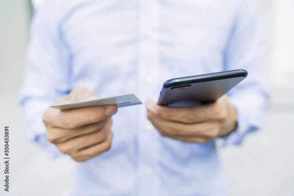Man holding a phone and card Man holding a phone and card
