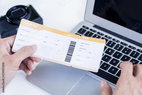 Man with boarding pass doing an online check in