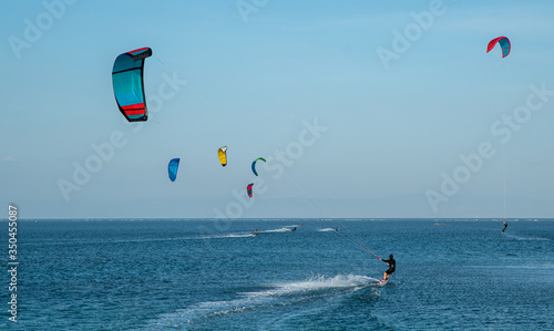 Fotografi kite on the beach, active water sports, kitesurfing at sea in the lagoon