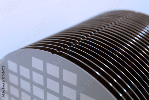 Close up of Silicon wafers grey color with chip cells prepared for production in a semiconductors manufacturing facility