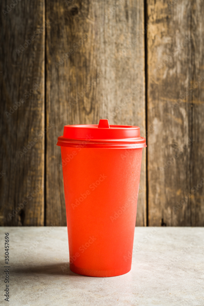 Plastic coffee cup for take away on the rustic wooden background. Selective focus. Shallow depth of field. Plastic coffee cup for take away on the rustic wooden background. Selective focus. Shallow depth of field.