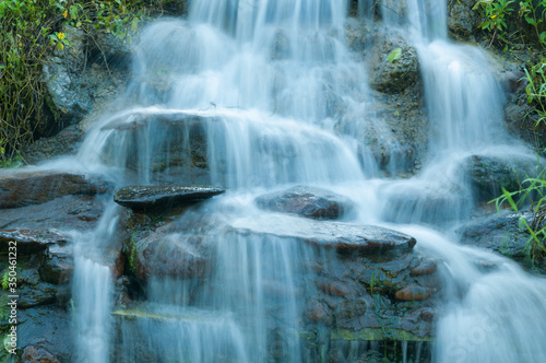 Closeup of small waterfall in the garden decorated