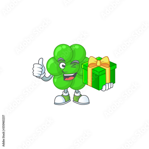 Happy smiley staphylococcus aureus cartoon mascot design with a gift box