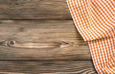Orange checkered picnic cloth on wooden background,food design tabletop,backdrop.