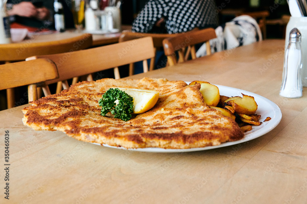 Φωτογραφία Wiener Schnitzel mit Pommes Frites und Bratkartoffel im Restaurant zum essen